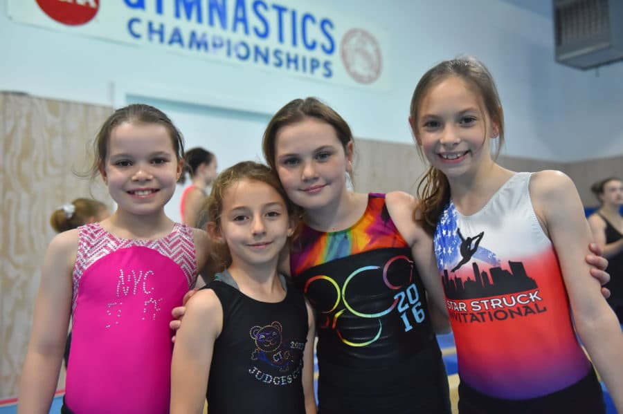 Four young campers in their gymnastics attire.