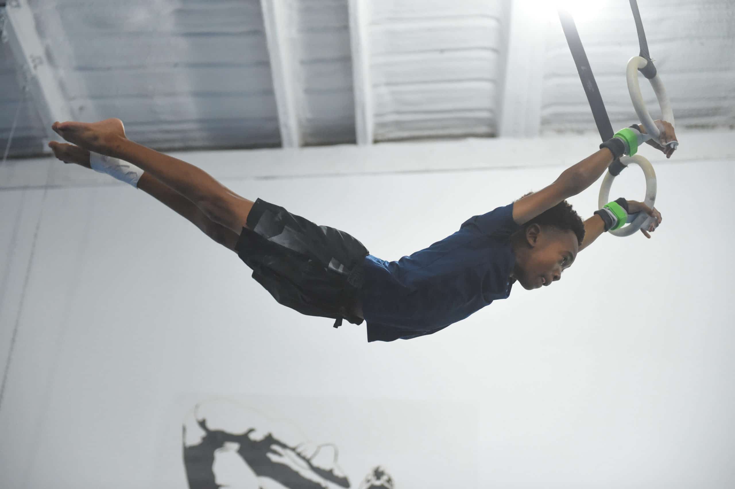 boy in the air with gymnastic rings