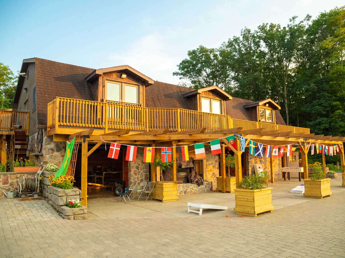 large cabin with balcony and string of flags hanging outside