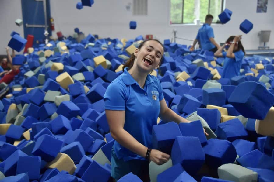 An IGC staff member poses in a pile of foam blocks.