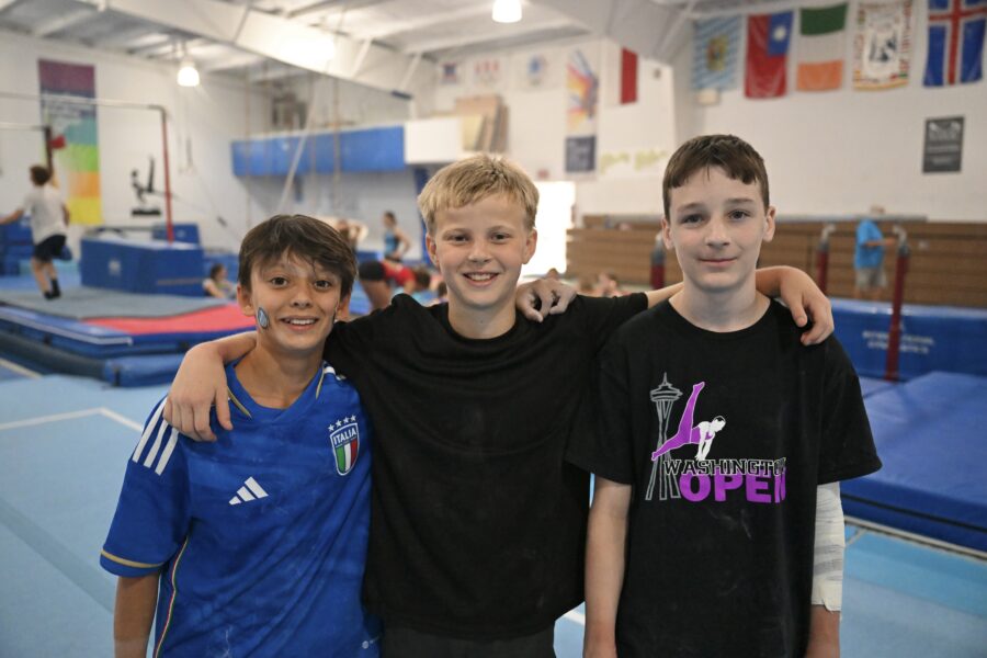 A group of boys enjoying themselves at gymnastics camp.