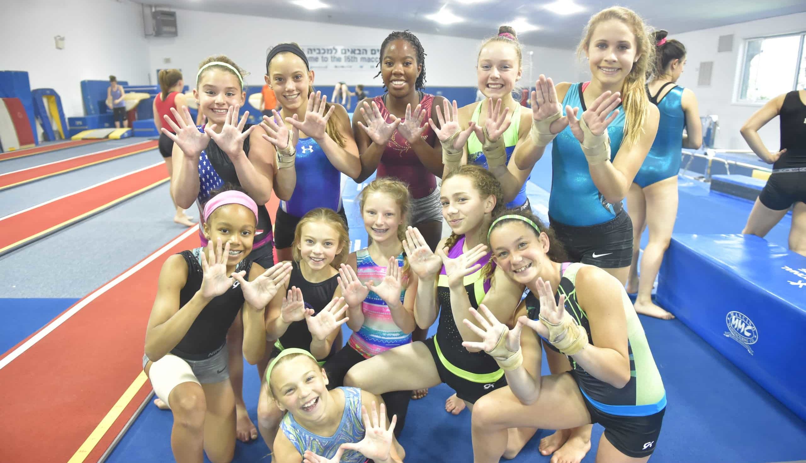 Kindness at Gymnastics Summer Camp.Gymnasts at IGC showing the Kount on Kindness hand sign.
