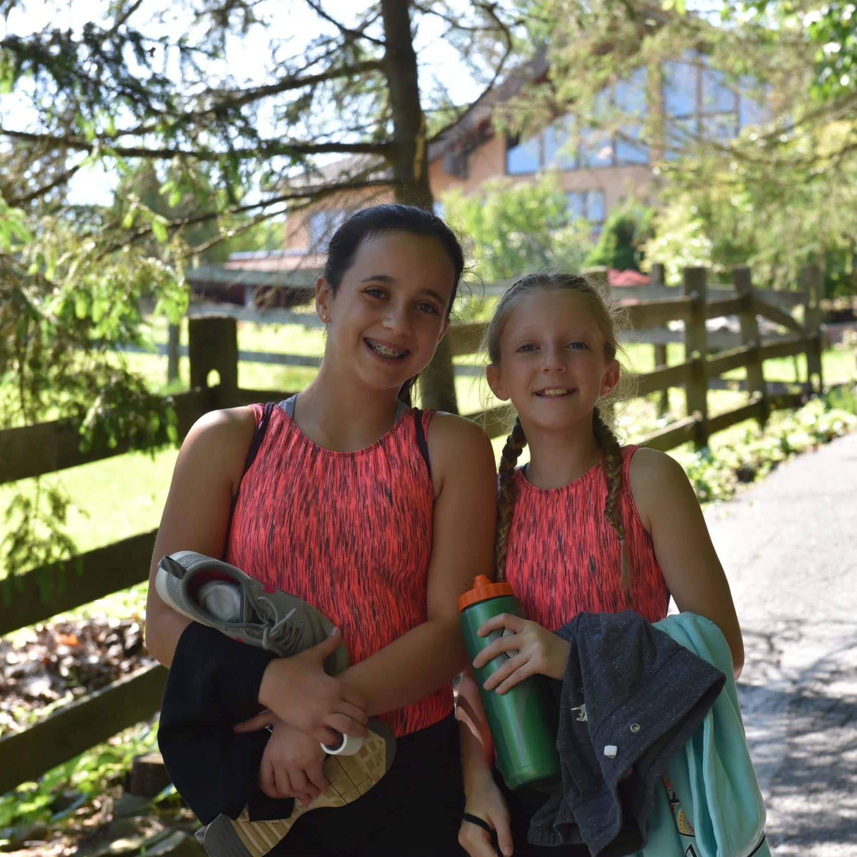 Two campers pose for a photo in matching shirts.