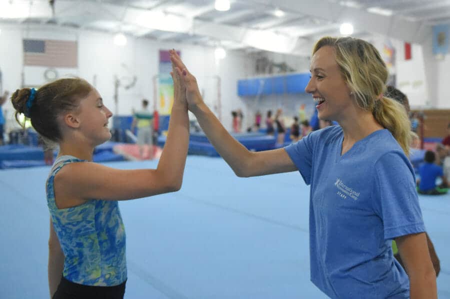 Nastia smiling and high fiving girl